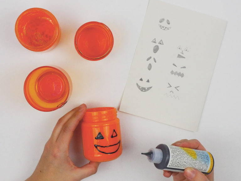 Gesichter werden auf die Halloween-Lichter aufgetragen. 
