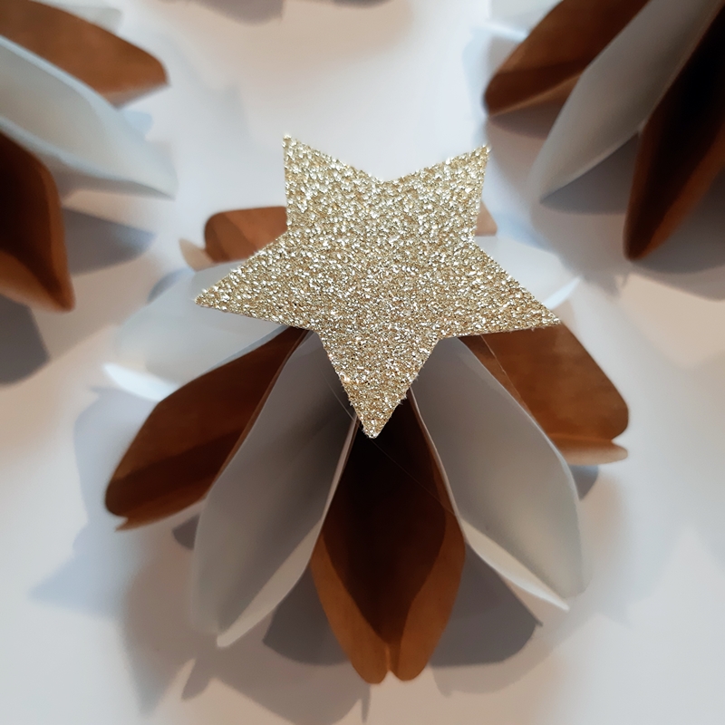 Ein Stern wird als Kragen auf das Kleid vom Weihnachtsengel geklebt